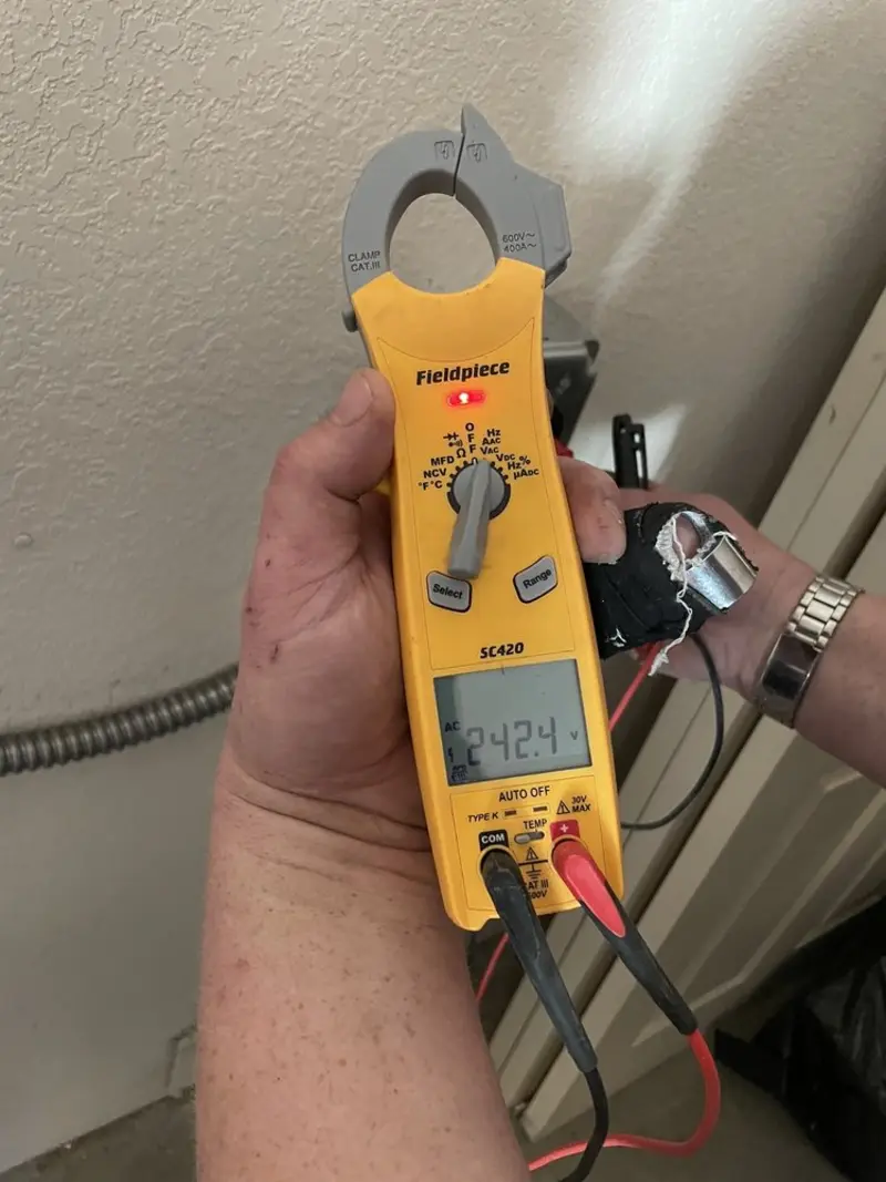 Voltage testing with clamp meter during Outlet Installation in Dilley